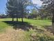 Lush backyard with mature trees offering shade and privacy in a serene setting at 5521 Colorow Dr, Morrison, CO 80465