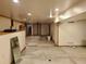 Basement with paneled walls, drop ceiling, concrete floor, and multiple doors leading to other rooms at 5521 Colorow Dr, Morrison, CO 80465