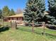 Ranch style home featuring a fence, mature trees and patio at 5521 Colorow Dr, Morrison, CO 80465