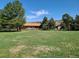 Ranch style home with large yard, mature trees and mountain backdrop at 5521 Colorow Dr, Morrison, CO 80465
