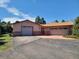 Ranch-style home with a two-car garage and brick accents at 5521 Colorow Dr, Morrison, CO 80465