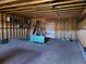 Unfinished garage with exposed framing, equipped with lighting, shelving, and ample space for various projects at 5521 Colorow Dr, Morrison, CO 80465