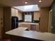 Well-lit kitchen featuring light cabinetry, a skylight, tiled backsplash, and modern appliances at 5521 Colorow Dr, Morrison, CO 80465