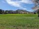 Picturesque view of a grassy green neighborhood with mountain views at 5521 Colorow Dr, Morrison, CO 80465