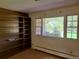 Living room featuring built-in shelving and large windows at 5521 Colorow Dr, Morrison, CO 80465