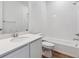Clean bathroom features a shower over tub, white tiles and a modern vanity at 9072 Telluride Ct, Commerce City, CO 80022