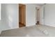 Bright bedroom featuring two doors and neutral carpet at 9072 Telluride Ct, Commerce City, CO 80022