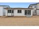 Back exterior view showcasing sliding glass door and large windows, providing lots of natural light at 9072 Telluride Ct, Commerce City, CO 80022