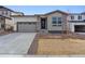 Charming single-story home featuring a two-car garage and modern stone accents at 9072 Telluride Ct, Commerce City, CO 80022
