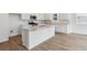 Bright kitchen featuring white cabinets, stainless steel appliances, and an island with a sink at 9072 Telluride Ct, Commerce City, CO 80022