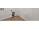 Neat laundry room with hardwood floors and white walls at 9072 Telluride Ct, Commerce City, CO 80022