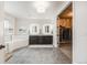 Bathroom featuring double sinks, modern mirrors, a soaking tub, and separate glassed-in shower at 10738 Braesheather Ct, Highlands Ranch, CO 80126