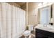 Cozy bathroom featuring a shower with curtain, neutral colors, and a dark vanity at 10738 Braesheather Ct, Highlands Ranch, CO 80126