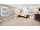 Bright primary bedroom featuring carpet, large windows, crown molding, and stylish decor at 10738 Braesheather Ct, Highlands Ranch, CO 80126