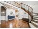 Grand entryway with wood floors, staircase, and views into other rooms at 10738 Braesheather Ct, Highlands Ranch, CO 80126