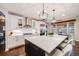 Bright kitchen boasts a large island, stainless steel appliances, and elegant pendant lighting at 10738 Braesheather Ct, Highlands Ranch, CO 80126