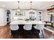 Modern kitchen features a large island with seating, pendant lighting, and stainless steel appliances at 10738 Braesheather Ct, Highlands Ranch, CO 80126