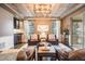 Cozy living room features a unique wood plank ceiling, comfortable seating, and access to an outdoor grill area at 10738 Braesheather Ct, Highlands Ranch, CO 80126