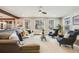 Cozy living room features stylish furniture, a ceiling fan, and large windows for natural light at 10738 Braesheather Ct, Highlands Ranch, CO 80126