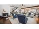 Bright living room featuring an open floor plan that seamlessly connects to the kitchen and staircase at 10738 Braesheather Ct, Highlands Ranch, CO 80126