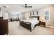 Spacious main bedroom features neutral walls, a dark wooden bed frame, and bright, natural light at 10738 Braesheather Ct, Highlands Ranch, CO 80126