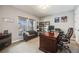 Well-lit home office with a large desk, comfortable seating, and ample natural light at 10738 Braesheather Ct, Highlands Ranch, CO 80126