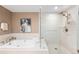 Bright bathroom featuring a soaking tub, elegant fixtures, and a glass-enclosed shower with a rainfall showerhead at 2400 E Cherry Creek South Dr # 209, Denver, CO 80209