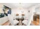 Elegant dining room with a modern chandelier and glass table at 2400 E Cherry Creek South Dr # 209, Denver, CO 80209