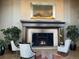 A cozy fireplace is flanked by plants and comfortable chairs at 2400 E Cherry Creek South Dr # 209, Denver, CO 80209