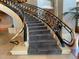 Close-up of carpeted staircase with decorative metal and wood railings at 2400 E Cherry Creek South Dr # 209, Denver, CO 80209