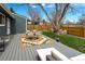 Landscaped backyard with a patio, dining area, and lush green lawn at 13020 Julian Ct, Broomfield, CO 80020