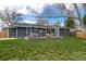 A backyard with a spacious deck is furnished with comfortable seating and views of the well-maintained lawn at 13020 Julian Ct, Broomfield, CO 80020
