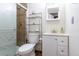 Clean, modern bathroom with glass shower, vanity, and shelving at 13020 Julian Ct, Broomfield, CO 80020