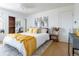 Light, airy bedroom with plush area rug and bright yellow accents at 13020 Julian Ct, Broomfield, CO 80020