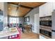 Bright kitchen with bar seating open to the living area and modern stainless-steel appliances at 13020 Julian Ct, Broomfield, CO 80020