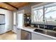 Bright kitchen features white cabinets, quartz counters, black backsplash, and stainless appliances at 13020 Julian Ct, Broomfield, CO 80020