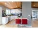Contemporary kitchen with white cabinets, dark backsplash, stainless steel appliances and bar seating at 13020 Julian Ct, Broomfield, CO 80020