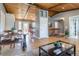 Spacious area with hardwood floors connecting living and dining spaces, featuring wood ceilings at 13020 Julian Ct, Broomfield, CO 80020
