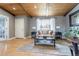 Bright living room with wood ceiling, hardwood floors, and a large window overlooking the street at 13020 Julian Ct, Broomfield, CO 80020
