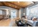 Inviting living room featuring a wood-beam ceiling, hardwood floors, and a comfortable seating area at 13020 Julian Ct, Broomfield, CO 80020