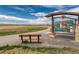 Scenic walking path with informational signage and a bench, offering a serene outdoor experience and mountain views at 13020 Julian Ct, Broomfield, CO 80020