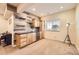 Modern basement wet bar with unique wood paneling, stylish fixtures, and built-in cabinets for entertaining at 16459 W 86Th Pl # B, Arvada, CO 80007