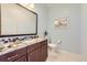 Charming powder room featuring granite countertops and modern fixtures at 16459 W 86Th Pl # B, Arvada, CO 80007