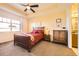 Comfortable bedroom with tray ceiling, large window, and wooden furnishings provides a relaxing retreat at 16459 W 86Th Pl # B, Arvada, CO 80007