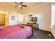 Well-lit bedroom with ceiling fan, dresser, and view into the hallway provides a relaxing personal space at 16459 W 86Th Pl # B, Arvada, CO 80007