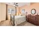 Cozy bedroom featuring a wrought iron bed frame and vintage dresser at 16459 W 86Th Pl # B, Arvada, CO 80007