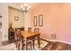 Cozy dining room with wood table, chandelier, and artwork create a warm, inviting space for meals at 16459 W 86Th Pl # B, Arvada, CO 80007