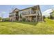 Exterior view showcasing a home's multiple decks and well-maintained lawn at 16459 W 86Th Pl # B, Arvada, CO 80007