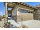 Attached two-car garage with painted wood door, adjacent to the covered front porch at 16459 W 86Th Pl # B, Arvada, CO 80007