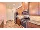 Stainless steel appliances, gas range and dark wood cabinetry are featured in this kitchen at 16459 W 86Th Pl # B, Arvada, CO 80007